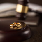 Image of wedding rings and a gavel, representing the updates to laws governing prenuptial agreement in WV.