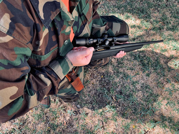 Image a kneeling hunter holding a rifle, representing how Jason Harwood at Harwood Legal, PLLC can help clients involved in hunting injuries in WV.
