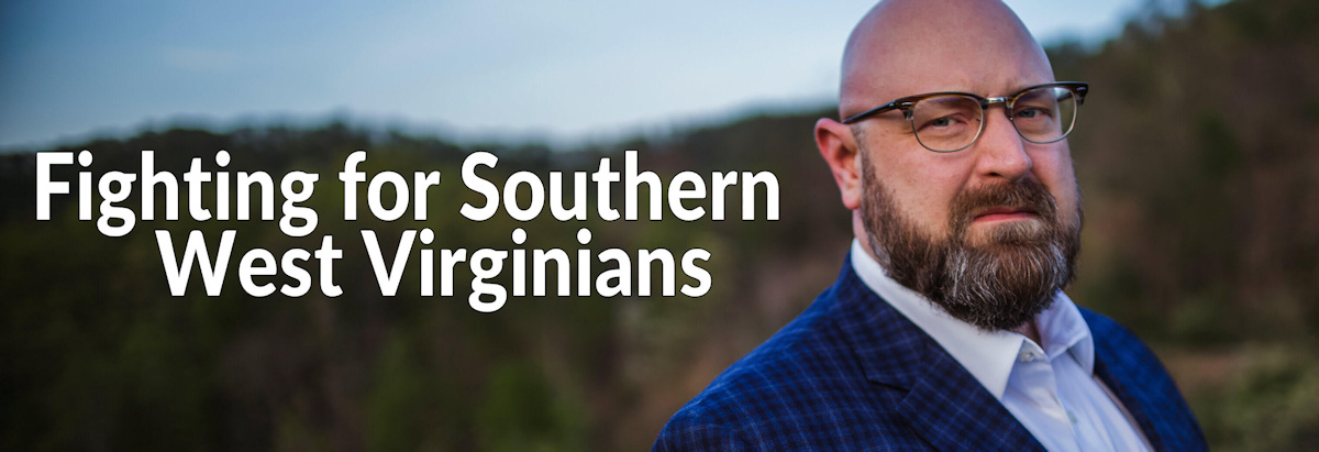 Image of Jason Harwood standing in front of the beautiful mountains of WV, representing the area he calls home and proudly serves the hardworking people in his area.