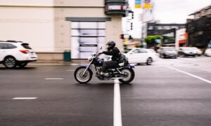 An image of a motorcycle rider on city streets, showing how Jason Harwood at Harwood Legal, PLLC helps clients who suffered WV motorcycle injuries fight for compensation.