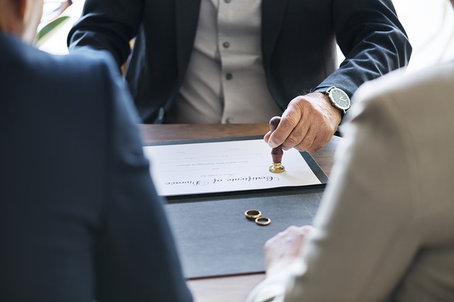 Image of a certificate of divorce and wedding rings, representing how Jason Harwood of Harwood Legal can help with your Boone County WV divorce or paternity action.