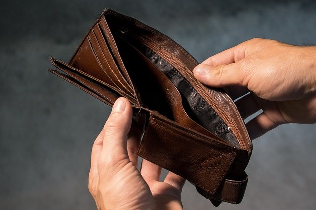 Image of two hands opening an empty wallet, illustrating how Jason Harwood at Harwood Legal can help when if you’re considering or have filed bankruptcy in WV.